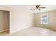 Spacious room featuring wood-look flooring, a ceiling fan, and a large window at 8199 Cousins St, Douglasville, GA 30134