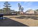 A spacious backyard with a wooden fence and mature trees on a sunny day at 15 Mary Jane Ln, Covington, GA 30016