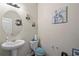 Neat powder room with pedestal sink and decorative wall art at 15 Mary Jane Ln, Covington, GA 30016
