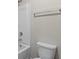 Clean bathroom featuring a white toilet, towel rack, and a partial view of a bathtub at 15 Mary Jane Ln, Covington, GA 30016
