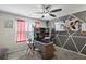 Inviting bedroom with a ceiling fan, a modern accent wall, and a functional desk area at 15 Mary Jane Ln, Covington, GA 30016