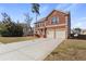 Charming two-story brick home features a two-car garage and well-maintained front lawn at 15 Mary Jane Ln, Covington, GA 30016