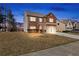 Charming two-story brick home features a two-car garage and well-maintained front lawn at 15 Mary Jane Ln, Covington, GA 30016