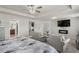 Bright main bedroom featuring a fireplace, sitting area, carpeting, and ceiling fan at 15 Mary Jane Ln, Covington, GA 30016