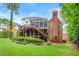 Expansive back exterior featuring a multi-tiered wooden deck and a screened porch that enhances outdoor living at 370 Fairleaf Ct, Alpharetta, GA 30022