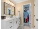 Stylish bathroom with white vanity, modern fixtures, and walk-in closet at 370 Fairleaf Ct, Alpharetta, GA 30022