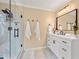 Modern bathroom features a glass shower, white vanity with black hardware, and neutral tile at 370 Fairleaf Ct, Alpharetta, GA 30022