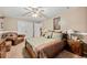 Comfortable bedroom features plush carpet, ceiling fan, and large closet at 370 Fairleaf Ct, Alpharetta, GA 30022