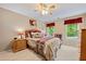 Bedroom with soft carpet, neutral walls and furniture, ceiling fan and two windows at 370 Fairleaf Ct, Alpharetta, GA 30022