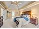 Tranquil bedroom featuring a tray ceiling, ceiling fan, and coordinated furnishings at 370 Fairleaf Ct, Alpharetta, GA 30022