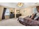 Spacious bedroom with neutral carpet, ceiling fan, two windows, and two dressers at 370 Fairleaf Ct, Alpharetta, GA 30022