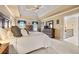 Bright bedroom featuring a tray ceiling, ceiling fan, and furniture for a comfortable setting at 370 Fairleaf Ct, Alpharetta, GA 30022