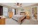 Comfortable bedroom featuring neutral tones, a ceiling fan, and two windows with curtains at 370 Fairleaf Ct, Alpharetta, GA 30022