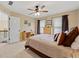 Spacious bedroom offering plush carpet, a ceiling fan, and windows providing ample natural light at 370 Fairleaf Ct, Alpharetta, GA 30022