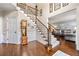 Inviting foyer with staircase, wood floors, and view into the living space at 370 Fairleaf Ct, Alpharetta, GA 30022