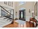 Elegant foyer featuring hardwood floors, staircase, and decorative lighting at 370 Fairleaf Ct, Alpharetta, GA 30022
