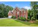 Traditional brick home features lush green lawn and meticulously maintained landscaping at 370 Fairleaf Ct, Alpharetta, GA 30022