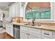 Kitchen boasts granite countertops, a stainless steel dishwasher, and a garden view window above the sink at 370 Fairleaf Ct, Alpharetta, GA 30022