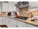Kitchen featuring granite countertops, a mosaic backsplash, stainless steel appliances, and ample cabinet space at 370 Fairleaf Ct, Alpharetta, GA 30022