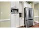 Modern kitchen with stainless steel refrigerator, built-in microwave, and white cabinets for a sleek look at 370 Fairleaf Ct, Alpharetta, GA 30022
