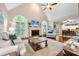Bright living room features vaulted ceilings, large windows, a fireplace, and an open layout with hardwood floors at 370 Fairleaf Ct, Alpharetta, GA 30022