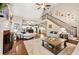 Expansive living room with open floor plan, fireplace, staircase, hardwood floors, and access to the kitchen at 370 Fairleaf Ct, Alpharetta, GA 30022