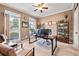 Bright office with two windows, stylish desk, and ample storage shelving for an ideal work-from-home environment at 370 Fairleaf Ct, Alpharetta, GA 30022