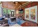 Brick walled sunroom with hardwood floors and french doors to house at 370 Fairleaf Ct, Alpharetta, GA 30022