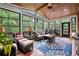 Inviting sunroom with wood ceiling, ceiling fan and large windows overlooking backyard at 370 Fairleaf Ct, Alpharetta, GA 30022