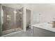 Bathroom featuring glass shower, gray cabinets, and tile floors at 3724 Via Secco Ln, Suwanee, GA 30024