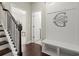 Inviting foyer with hardwood floors, staircase, and custom wall decor at 3724 Via Secco Ln, Suwanee, GA 30024