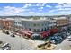 An eye-level shot showcases the building's architectural style and vibrant surroundings of this mixed-use, multi-story development at 3724 Via Secco Ln, Suwanee, GA 30024