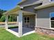 Side view of a covered back porch with classic column design and brick foundation at 3818 Southfield Ct, Loganville, GA 30052