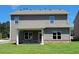 Back of the home showing a covered patio and brick accents at 3818 Southfield Ct, Loganville, GA 30052