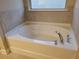Bright bathroom with a large soaking tub and chrome fixtures at 3818 Southfield Ct, Loganville, GA 30052