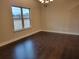 Dining room with dark hardwood floors, a modern chandelier, and a large window at 3818 Southfield Ct, Loganville, GA 30052