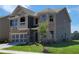 Two-story home with brick and gray siding, showing a manicured lawn with a young tree at 3818 Southfield Ct, Loganville, GA 30052