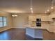 Bright kitchen with granite counters, stainless appliances, and hardwood floors at 3818 Southfield Ct, Loganville, GA 30052