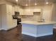 Open kitchen with granite countertops, white cabinetry, and modern stainless steel appliances at 3818 Southfield Ct, Loganville, GA 30052