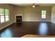 Bright living room with a fireplace and large windows providing plenty of natural light at 3818 Southfield Ct, Loganville, GA 30052