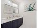 Modern bathroom with double sink vanity, elegant light fixtures, and a large mirror at 1245 Liberty Nw Pkwy # 807, Atlanta, GA 30318