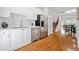 Modern kitchen featuring stainless steel appliances, white cabinets, and hardwood floors at 1245 Liberty Nw Pkwy # 807, Atlanta, GA 30318