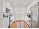 Galley kitchen features stainless steel appliances, white cabinets, and wood floors at 1245 Liberty Nw Pkwy # 807, Atlanta, GA 30318