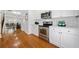 Kitchen featuring stainless appliances, white cabinets, and hardwood floors at 1245 Liberty Nw Pkwy # 807, Atlanta, GA 30318