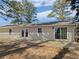 Large patio with sliding doors offering natural light and views of the surrounding landscape at 5520 Morning Creek Cir, Atlanta, GA 30349