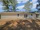 An inviting backyard featuring a concrete patio and views of mature trees at 5520 Morning Creek Cir, Atlanta, GA 30349