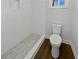 Bathroom featuring modern white toilet and subway tile shower with grey tiled flooring at 5520 Morning Creek Cir, Atlanta, GA 30349