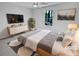 This staged bedroom features neutral walls, updated ceiling fan, and an abundance of natural light at 5520 Morning Creek Cir, Atlanta, GA 30349