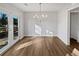 Dining room features modern lighting and French doors to the backyard at 5520 Morning Creek Cir, Atlanta, GA 30349