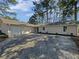 Well-maintained single-Gathering home with a spacious driveway and mature trees at 5520 Morning Creek Cir, Atlanta, GA 30349